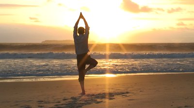yoga-on-a-beach-at-sunrise